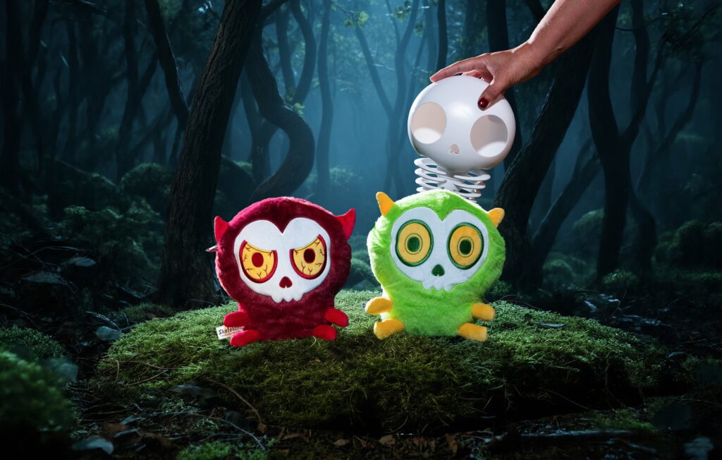 Skelekins Anger and Surprise plush in a misty forest, skin unzipped to reveal the skeleton